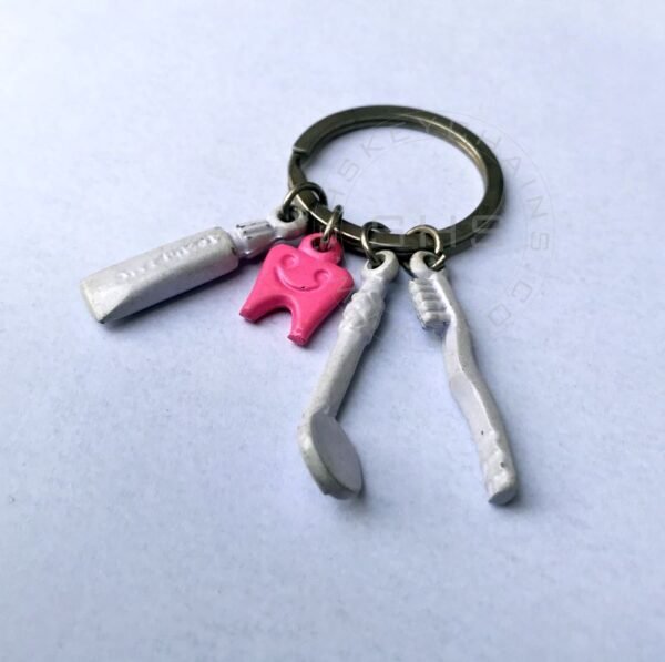 Pink tooth with Brush, Paste and Mirror Charms keychain